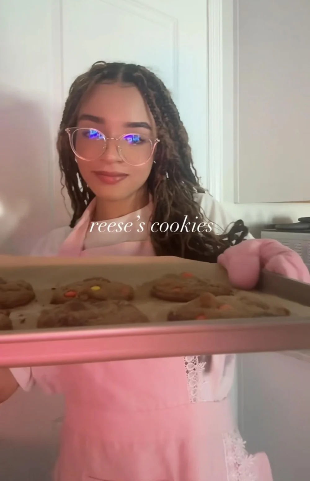 The baker behind MJ Baked It holding a fresh tray of cookies